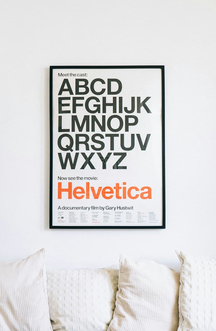 Reference image — a framed poster hung on a living room wall