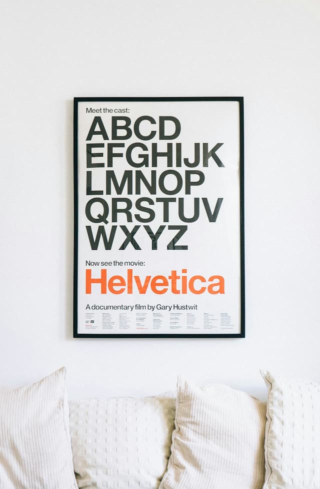 Reference image — a framed poster hung on a living room wall